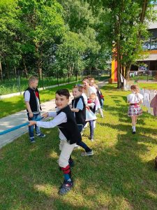 Dzieci przeciągają linę z rodzicami