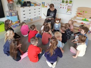Nauczyciel czyta dzieciom bajkę