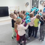 Dzieci bawią się zielonymi piłkami.