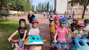 Dziewczynki na rowerach stoją w Miasteczku Ruchu Drogowego.