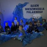 Dzieci siedzą na dywanie